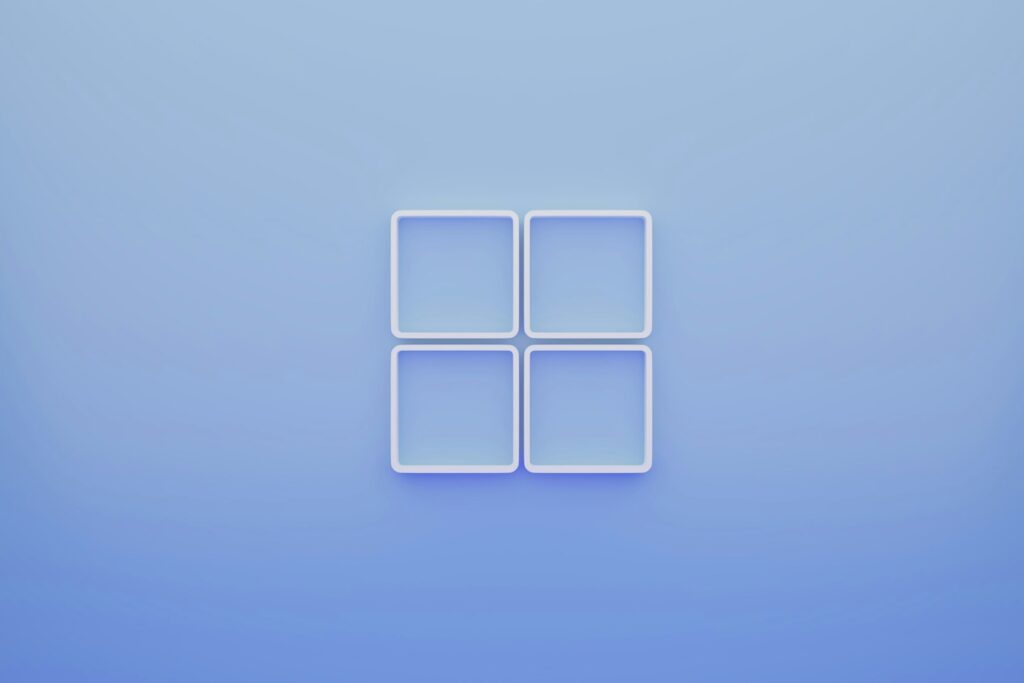 Four white square frames arranged in a grid on a soft blue background