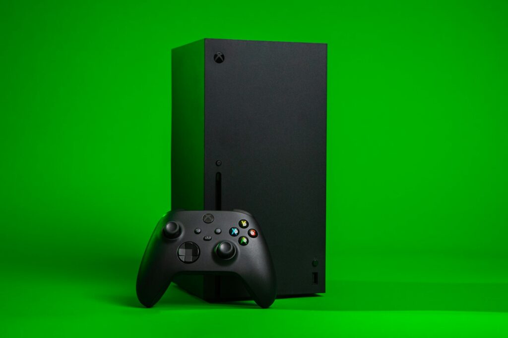 black xbox one console with controller